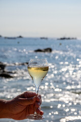 Summer time in Provence, two glasses of cold champagne cremant sparkling wine on sandy beach near...