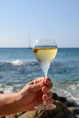 Summer time in Provence, two glasses of cold champagne cremant sparkling wine on sandy beach near Saint-Tropez in sunny day, Var department, France