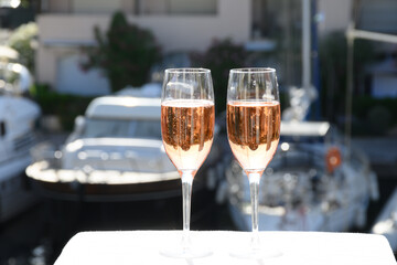 Summer party, drinking of French brut rose champagne sparkling wine in glasses in yacht harbour of Port Grimaud near Saint-Tropez, French Riviera vacation, France