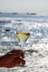 Summer time in Provence, two glasses of cold champagne cremant sparkling wine on sandy beach near Saint-Tropez in sunny day, Var department, France