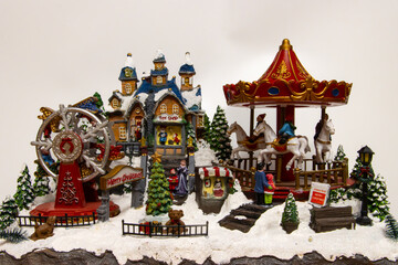Christmas village miniature with carousel, toy shop and ferris wheel