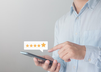 Customer review satisfaction feedback survey concept. Client or employee using smartphone are happy to give 5 star rate for service experience opinion on online survey. Business Quality is Service.