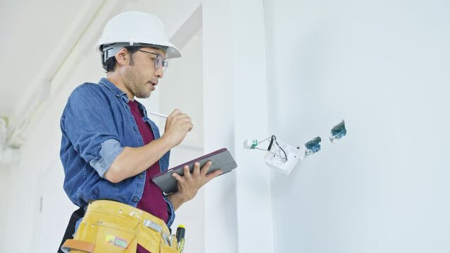 The property Inspector checks or inspects equipment in the renovation house and improvement project.