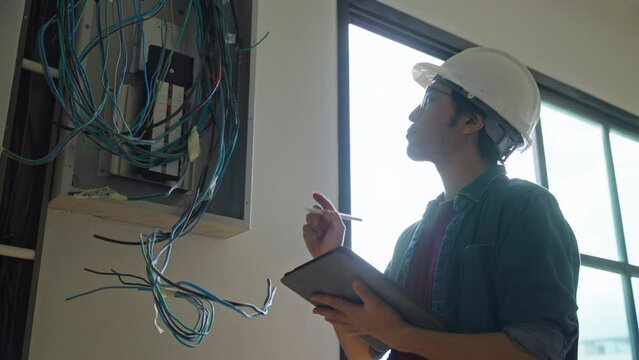 The property Inspector checks or inspects equipment in the renovation house and improvement project.