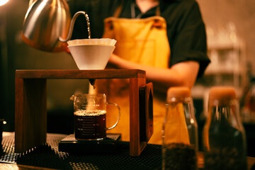 People use coffee making equipment and tools at home kitchens to brew hot coffee that drips into...