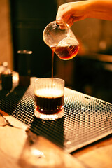 People use coffee making equipment and tools at home kitchens to brew hot coffee that drips into their cups, Professional barista preparing coffee over coffee maker and drip kettle