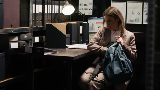 Detective inspector analyzing evidence in incident room reviewing files and cross-referencing information on laptop. Placing personal computer on table inspector meticulously examining clues.