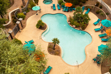 Aerial Top View Of Swimming Pool With Stairs, Empty Chaise Sun Bed Lounge, Umbrella, Palms And...