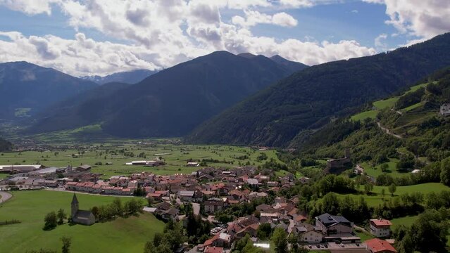 areal footage of Italian village in Apls surrounded by mountains 