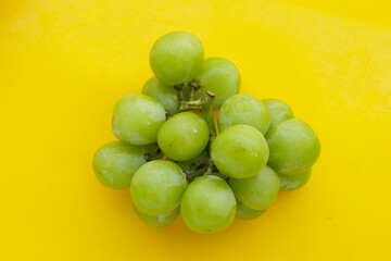Shine muscat grape on yellow background.