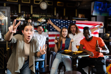Fototapeta premium Smiling man and woman drinking alcohol and having conversation on party in nightclub