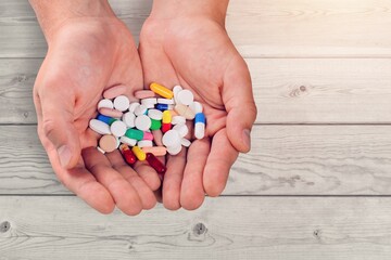 Woman hands with medical pills. Contraception reduces