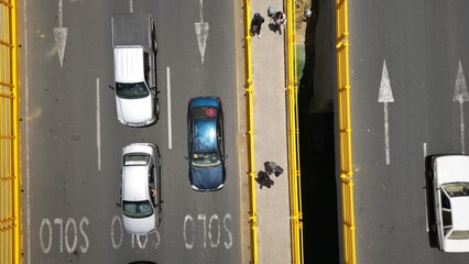 Aerial view of bridge, cars and people crossing 