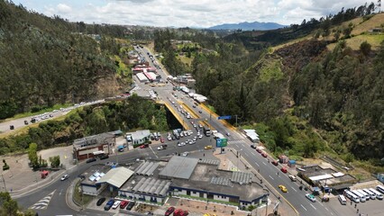 IPIALES, COLOMBIA - October 3, 2023: some cars driving through the migration checkpoint in the border line between Colombia and Ecuador, aerial shot