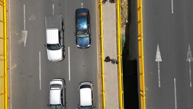 Aerial view of bridge, cars and people crossing 
