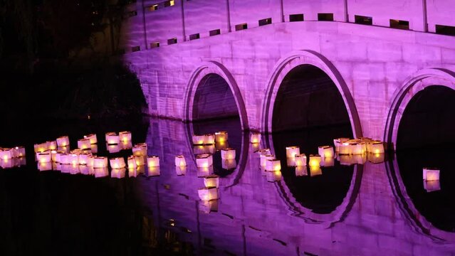 Chinese lanterns float below a traditional bridge during an Autumn moon festival