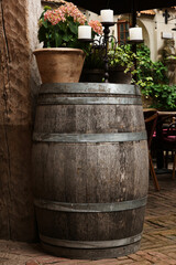 Traditional wooden barrel, beautiful houseplant and candlestick outdoors