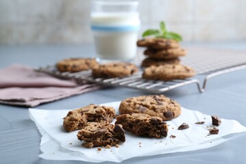 Tasty chocolate chip cookies on light grey table, closeup