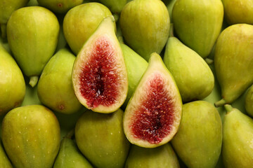 Halves of green fig on fresh fruits, top view
