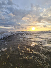 Ocean wave on colorful dramatic sky background