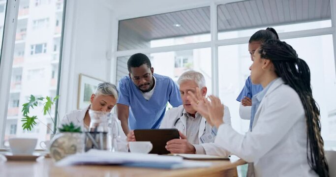 Healthcare, teamwork and group of doctors in discussion in the hospital boardroom for treatment plan. Diversity, meeting and team of medical workers planning and brainstorming for diagnosis in clinic