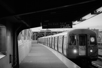 Black and white photo of the G Train arriving at the Smith Street station over the Gowanus Canal in Brooklyn, New York.