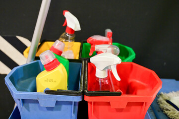 Basket with Cleaning products at home. Plastic bottles with disinfectant, detergent and soap. Cleaning chemicals in spray. 