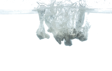 Construction Rock gravel throw fall into clear water with air bubble. Gray stone pebbles rock drop to clear water of cement. White background isolated freeze element