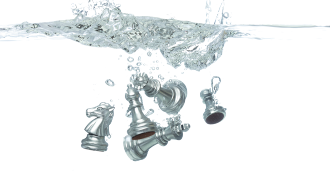 Silver Chess many Figure throw fall into clear water with air bubble. Unpredictable failure of business plan strategy and human resources organization risk management. White background isolated