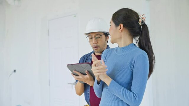 The property Inspector and house owner checks or inspects equipment in the renovation house improvement project.