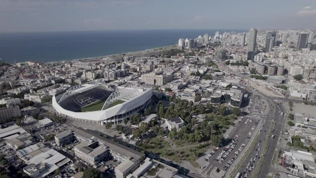 Raw file - Huge Parallax from a high altitude of Bloomfield football Stadium, It hosted musical acts from time to time and It is the home of three soccer clubs - tel aviv skyline at the background