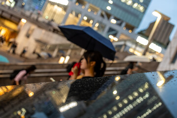 woman riding the escalator in Tokyo on a rainy day