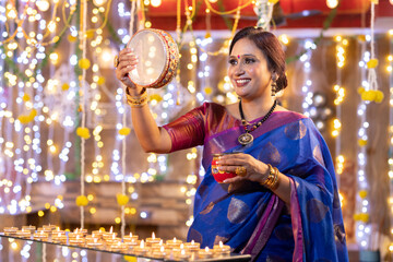 Woman looking through sieve during Karva Chauth ceremony
