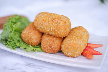 Fried croquettes on a white plate. Selective focus.