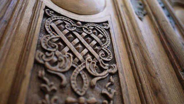 Beautiful elegant adornment ornamentation engraved on wooden ancient door, traditional antique building architecture