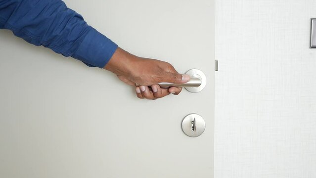 Man's Hand Opening door close up 