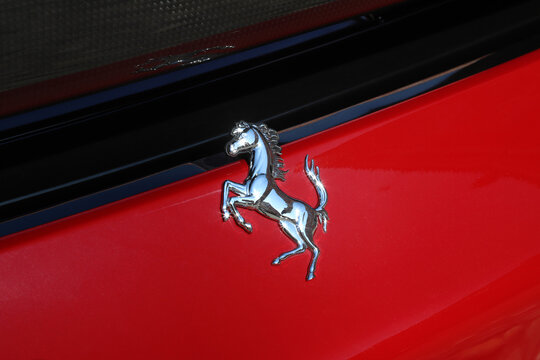 Maranello, Modena, Italy, year 2023 - Ferrari symbol of the metallic rampant horse on the bodywork of a italian sports car