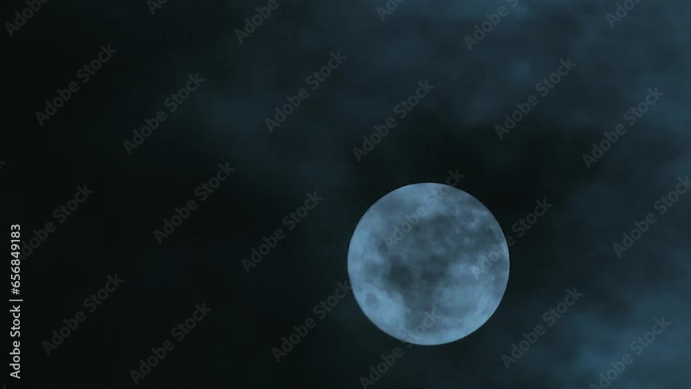 Poster full moon floating in the night cloudy sky. close-up. clouds at full moon. place to insert text. a s