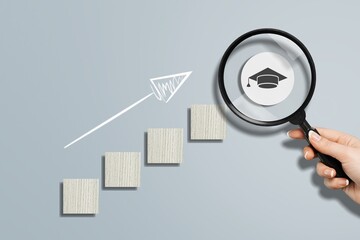 Steps of education concept. Graduation cap in Magnifying glass.