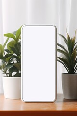 Mockup smartphone with blank screen on table with green plant