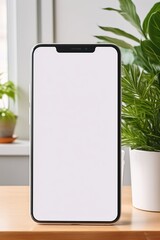 Mockup smartphone with blank screen on table with green plant