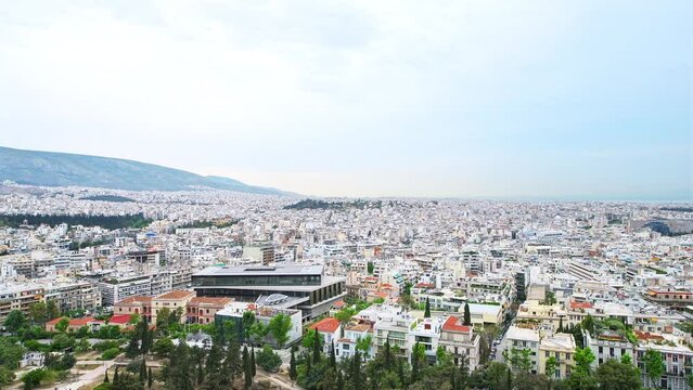 Athens Greece street cityscape Acropolis high angle aerial view on rooftop buildings, Lofos Filopappou park by Saronic gulf Mediterranean sea