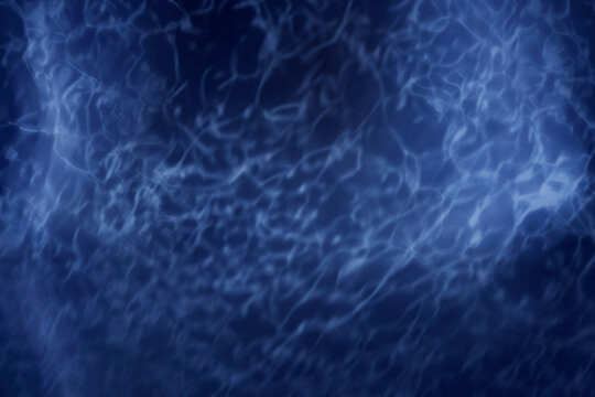 water reflection effect dark blue background with glitter lighting 