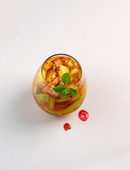 pieces of fresh fruit mixed with sweet peanut sauce and fresh pickled fruit in a glass cup