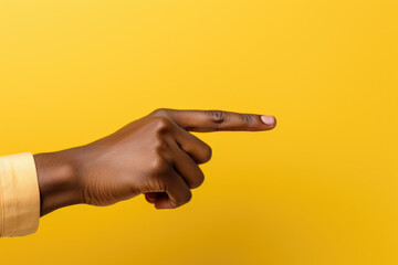 Person is pointing at something on vibrant yellow background. This image can be used to illustrate communication, direction, or decision-making concepts. - Powered by Adobe