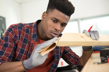 a man sanding a wooden table