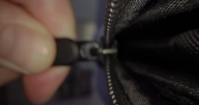 Macro video of closing a bag or jacket with a zipper. High quality 4k footage
