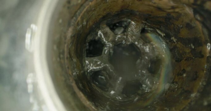 Kitchen Cleanup: High Magnification of Dishwasher Waste in Drainage System. High quality 4k footage