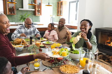 African american parents, children and grandparents celebrating at thanksgiving dinner