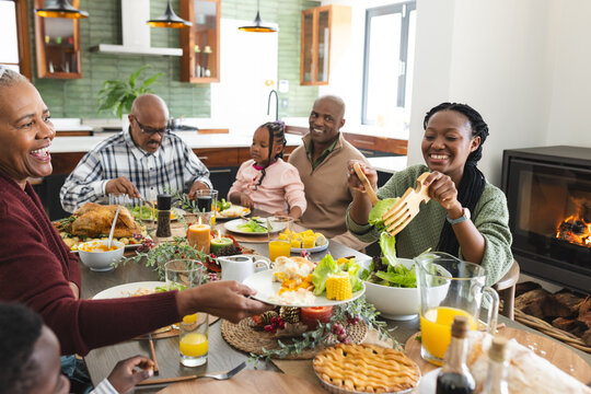 African American Parents, Children And Grandparents Celebrating At Thanksgiving Dinner